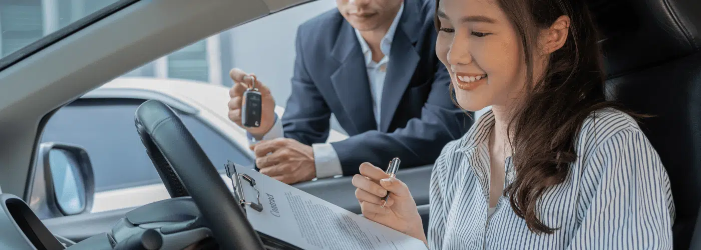 A woman receiving a car title pawn near her.